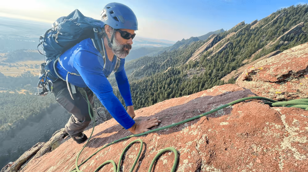 Photo of man climbing the flatirons in Boulder, CO