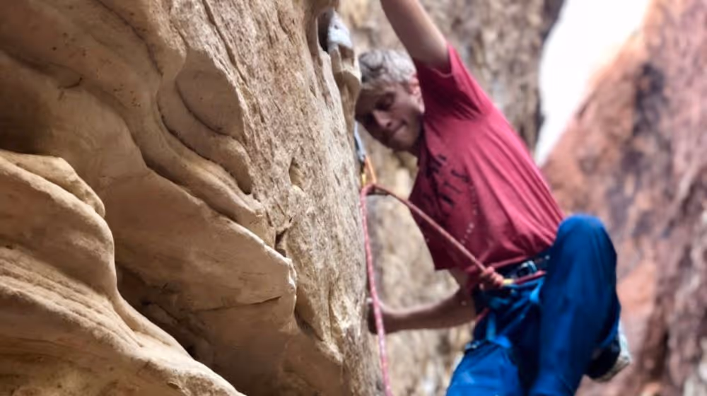 Photo of young man climbing in a Canyon