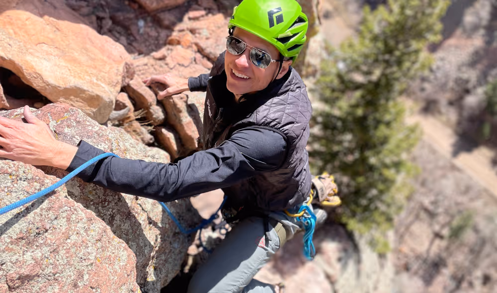 Man dressed properly for rock climbing outdoors