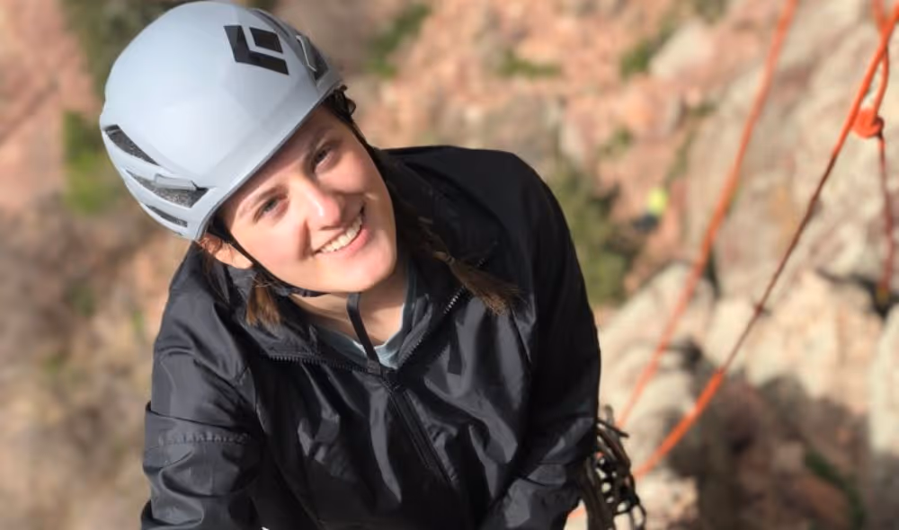 Woman enjoying learning to rock climb with Alpine to the Max