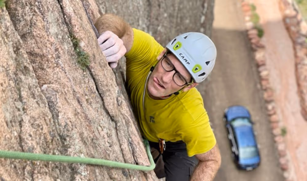 Middle aged man rock climbing in Eldorado Canyon State Park