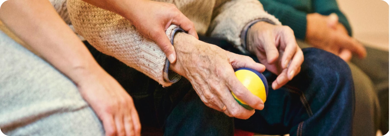 Old man holding a car, with a young hand holding his