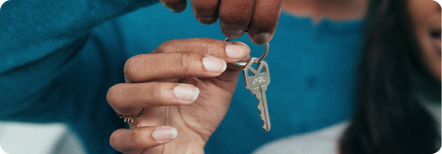 Woman being handed a key