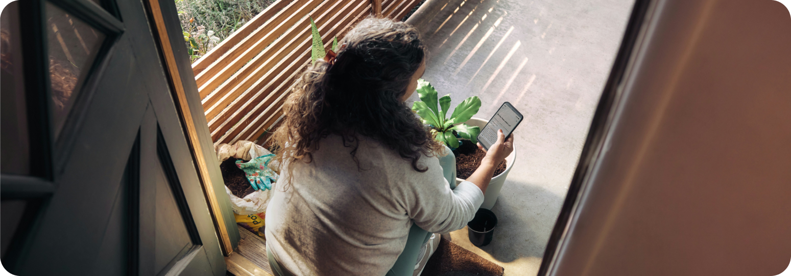 Woman looking at a phone outside