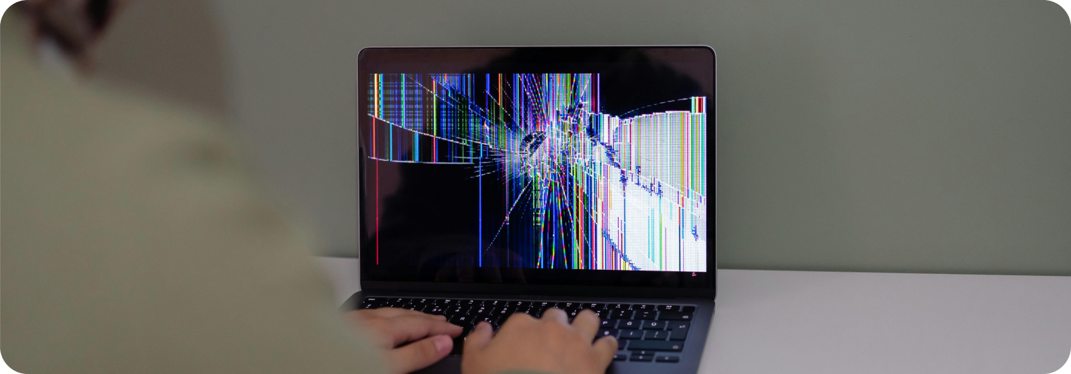 Man typing on a broken computer