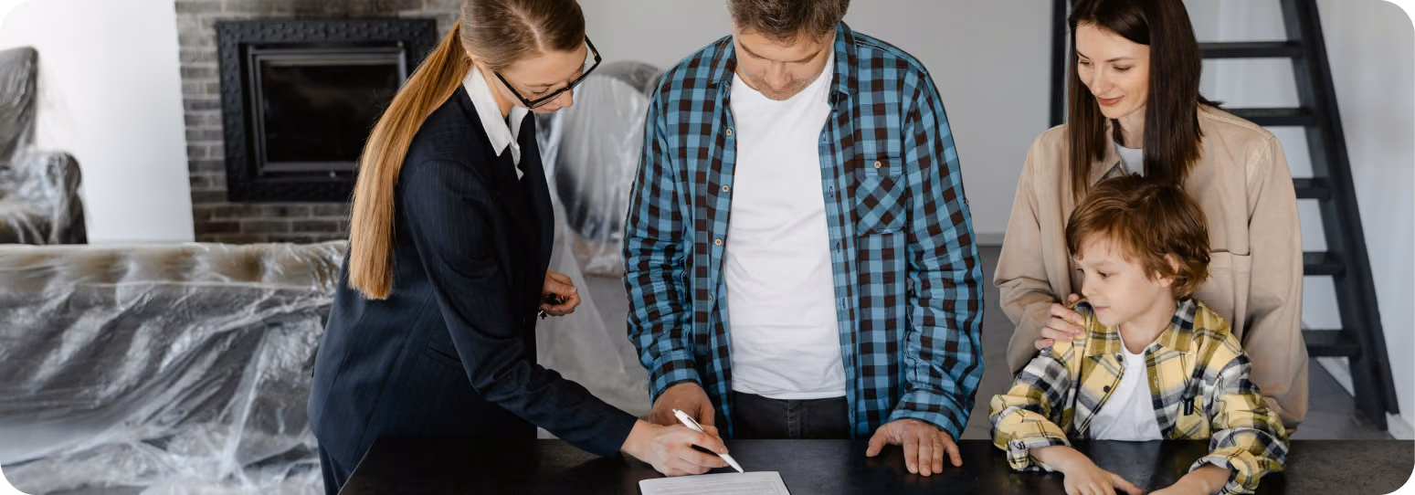 A leasing agent guiding a family through signing a contract