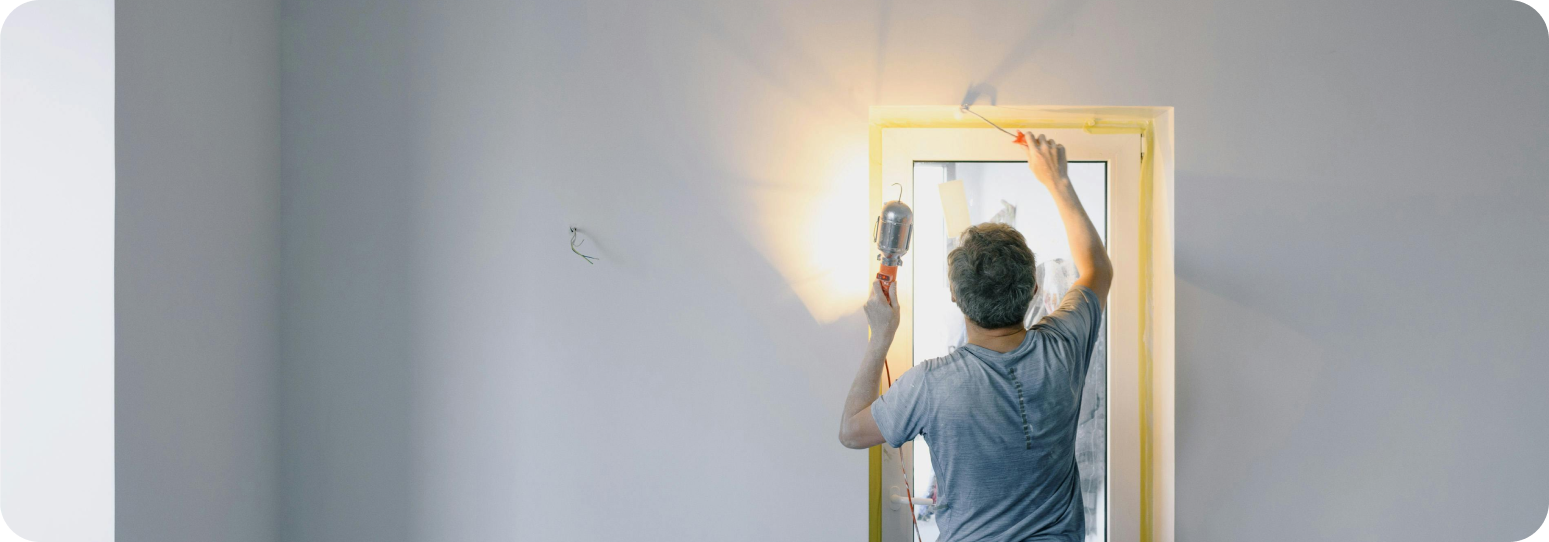 Repair man fixing a mirror