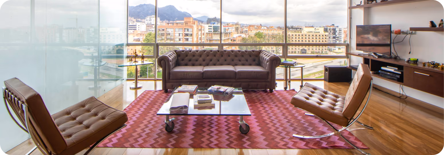 An apartment with a couch and chairs and a tv