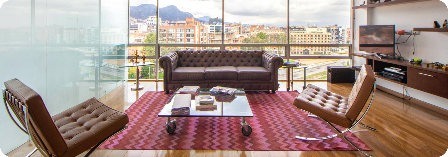An apartment with a couch and chairs and a tv