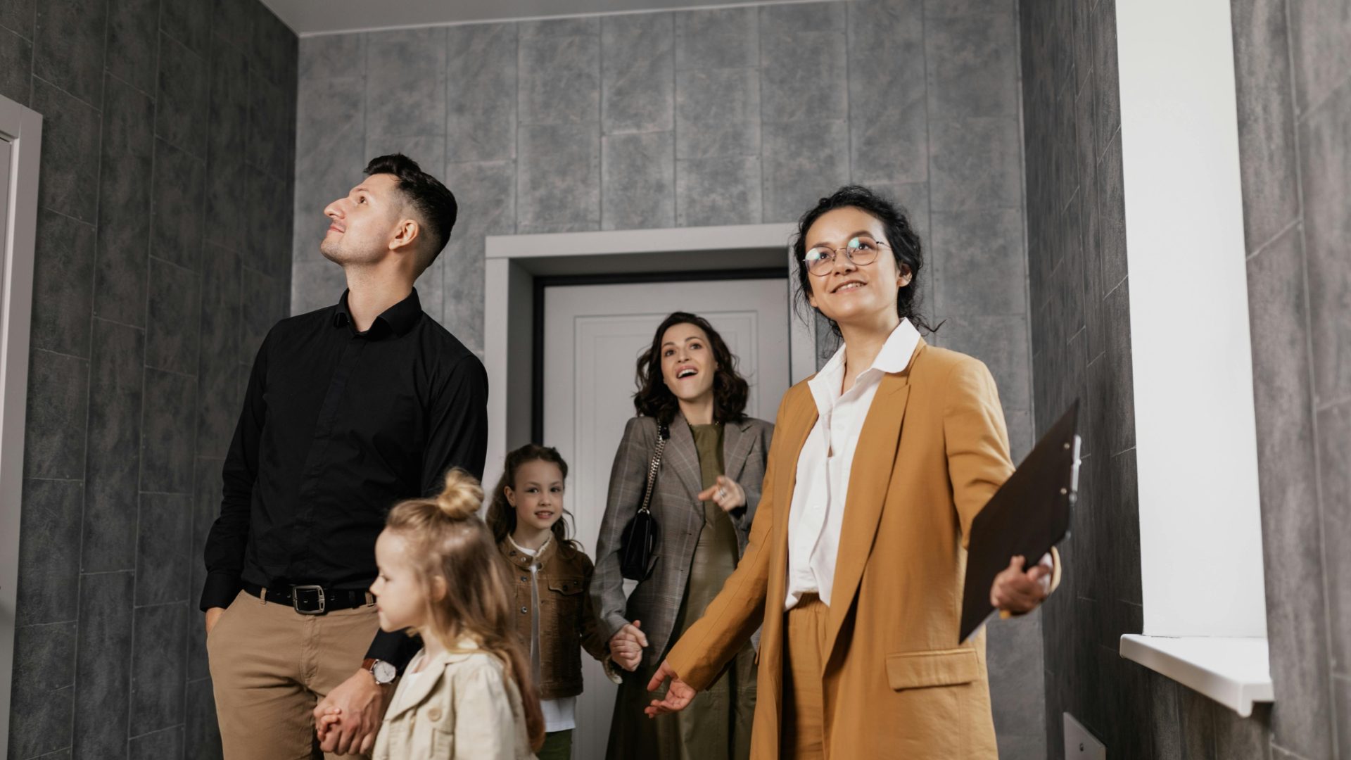 A family with a property manager looking at a new apartment