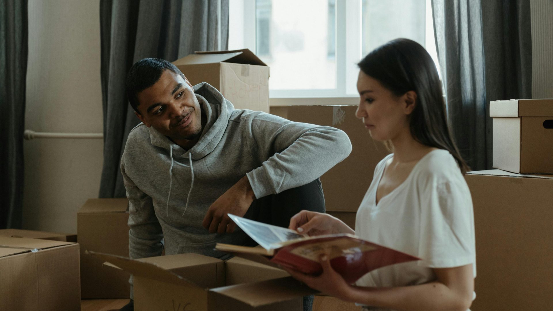 A couple sitting together unboxing their items