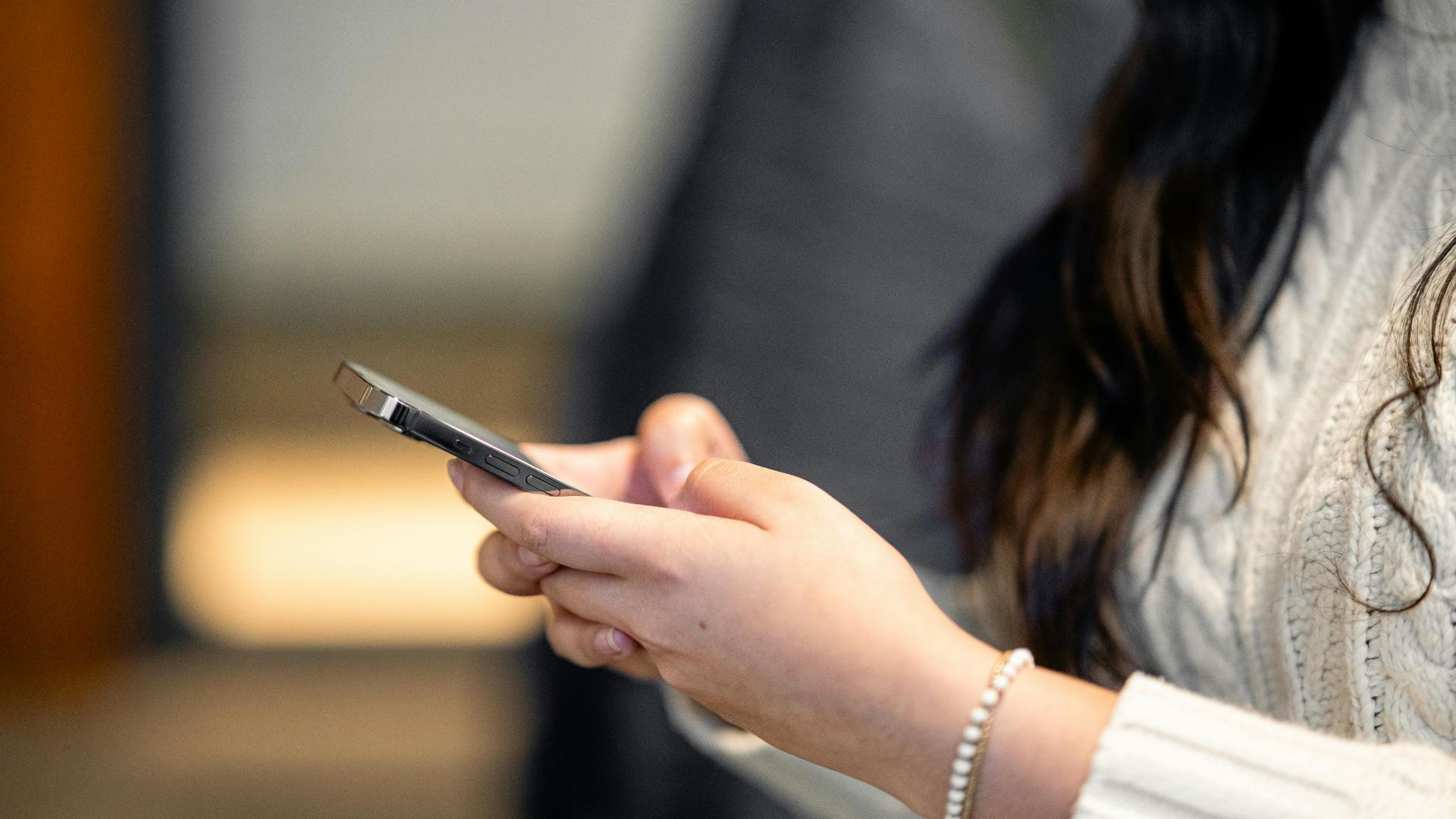 A lady typing on her phone