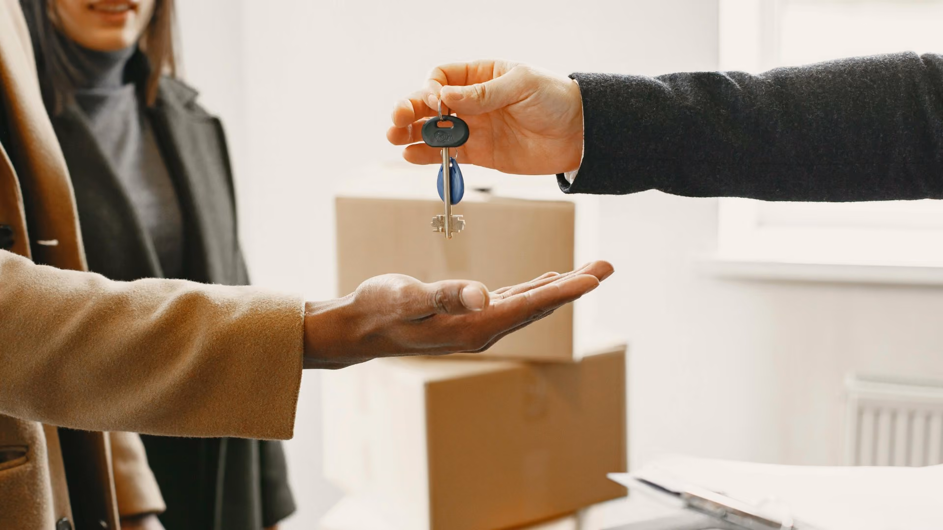 Leasing professional handing apartment keys to a new resident during move-in.