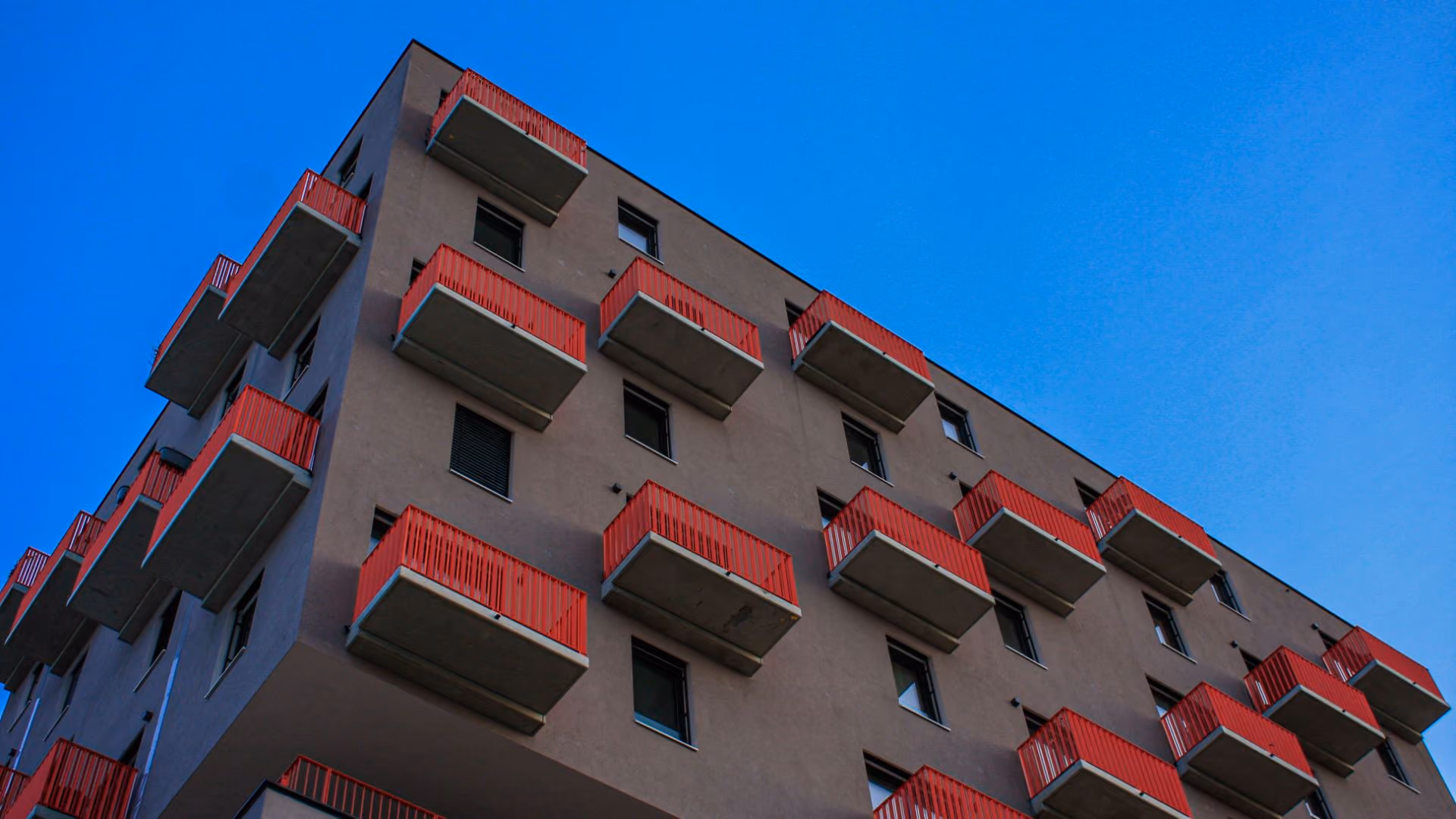Modern apartment building with balconies, representing rental living and apartment communities.