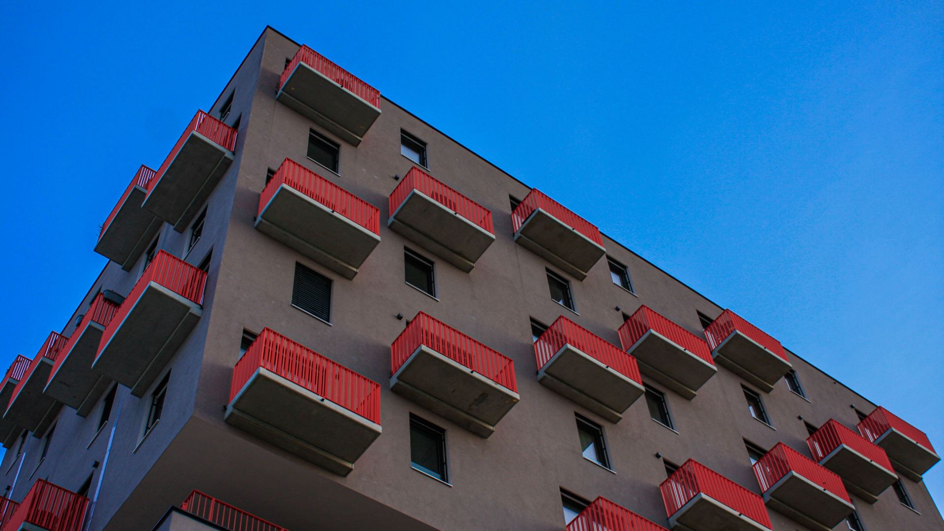 Modern apartment building with balconies, representing rental living and apartment communities.