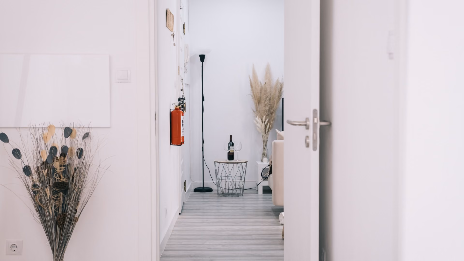 Bright apartment entryway featuring minimalist décor, floor lamp, and space-saving design ideas for renters.