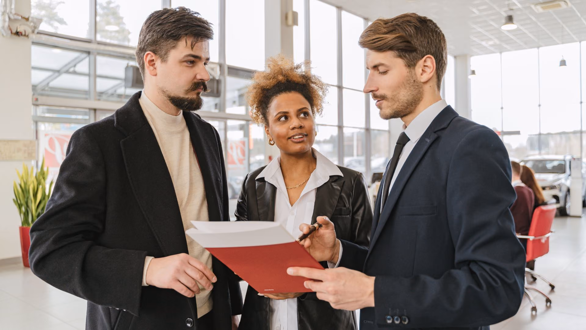 Property manager reviewing documents with prospective residents during an in-person consultation.