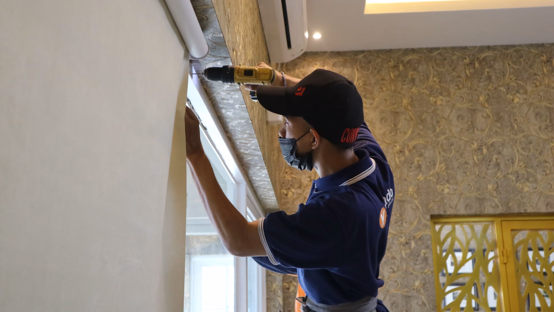 Maintenance technician completing a repair inside a resident's apartment.