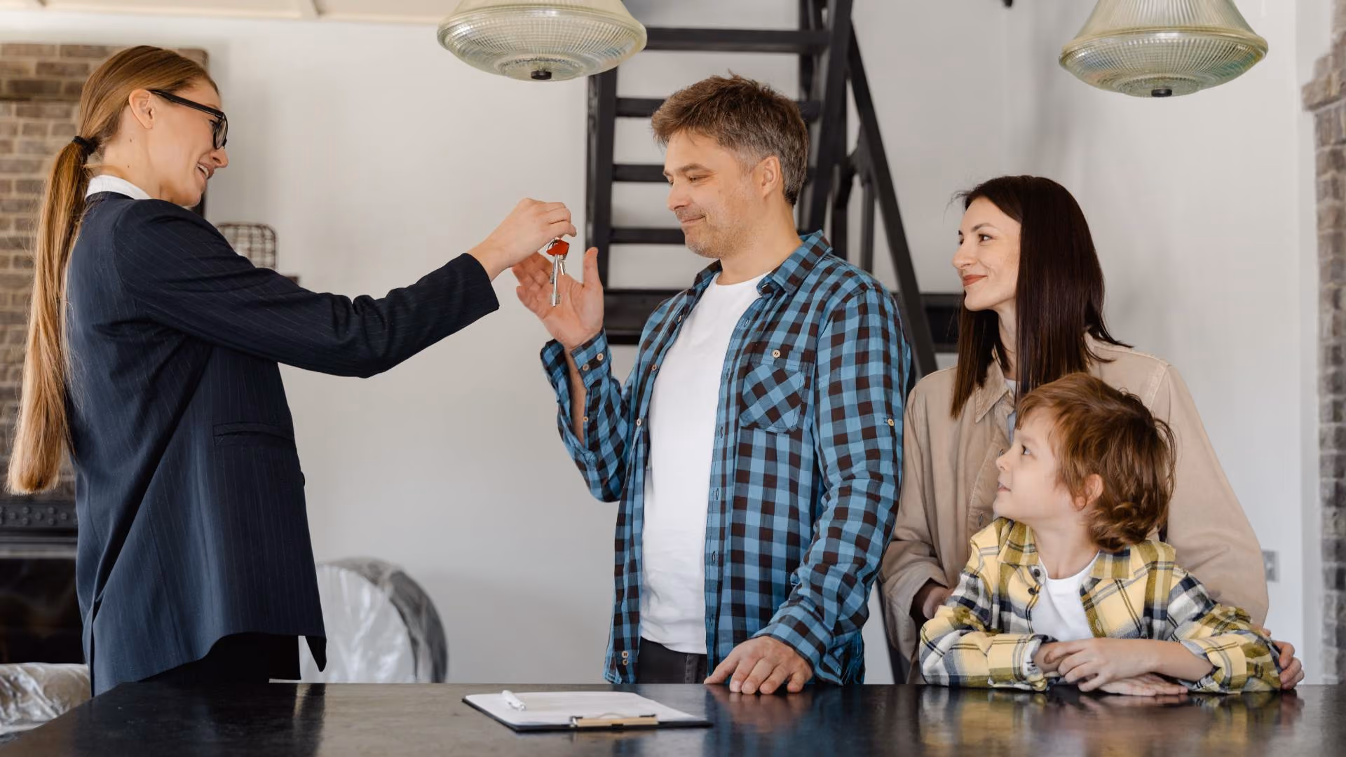 Leasing consultant handing apartment keys to new residents during the move-in process in a modern apartment community.