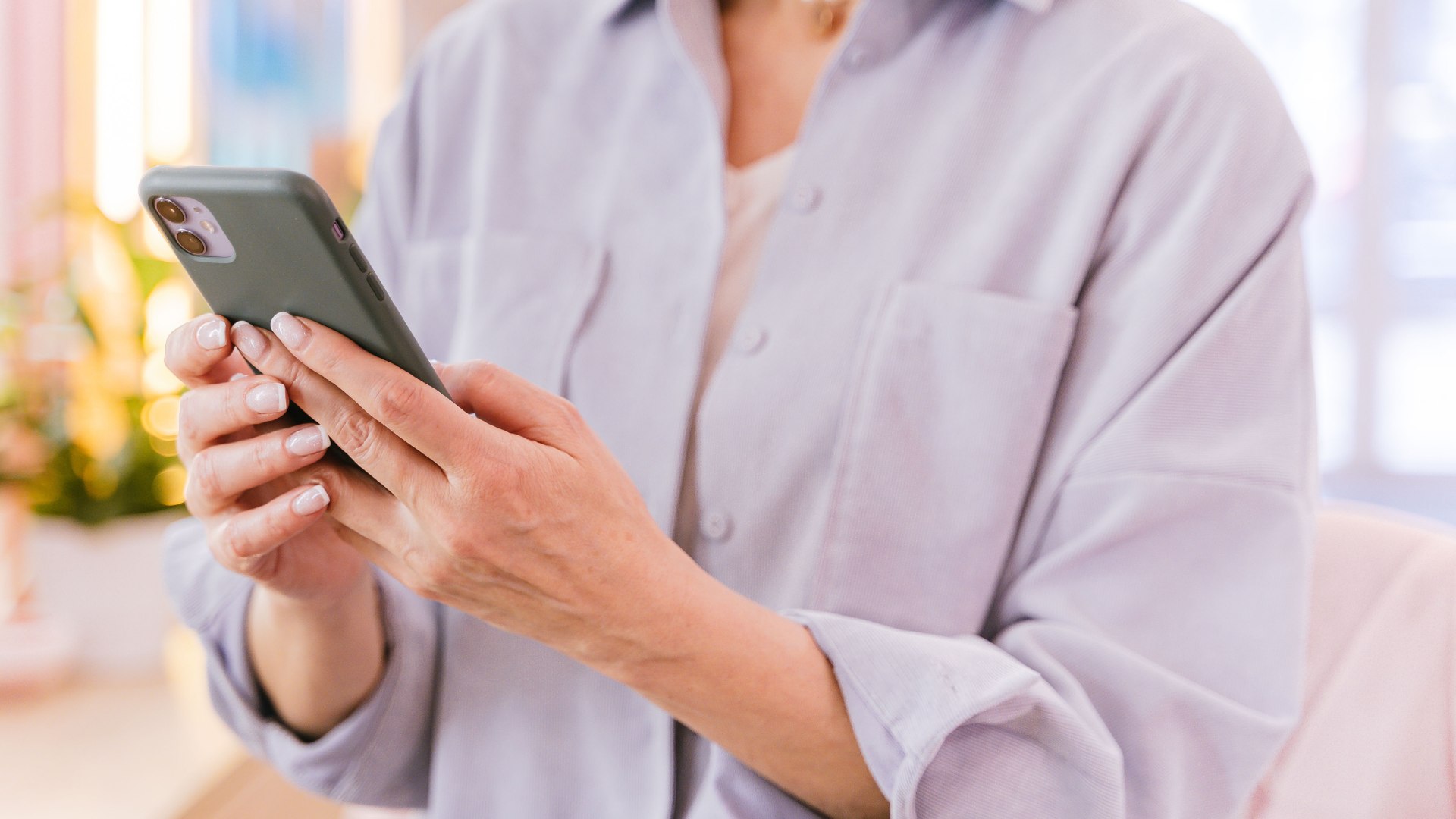 Resident using a smartphone to access apartment resources and financial education.