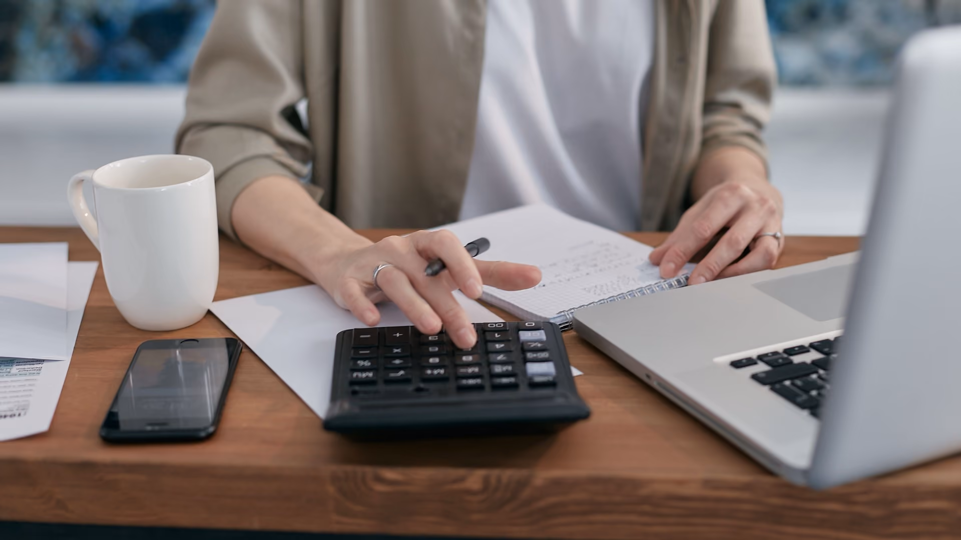 Two renters reviewing bills and calculating monthly housing expenses together.