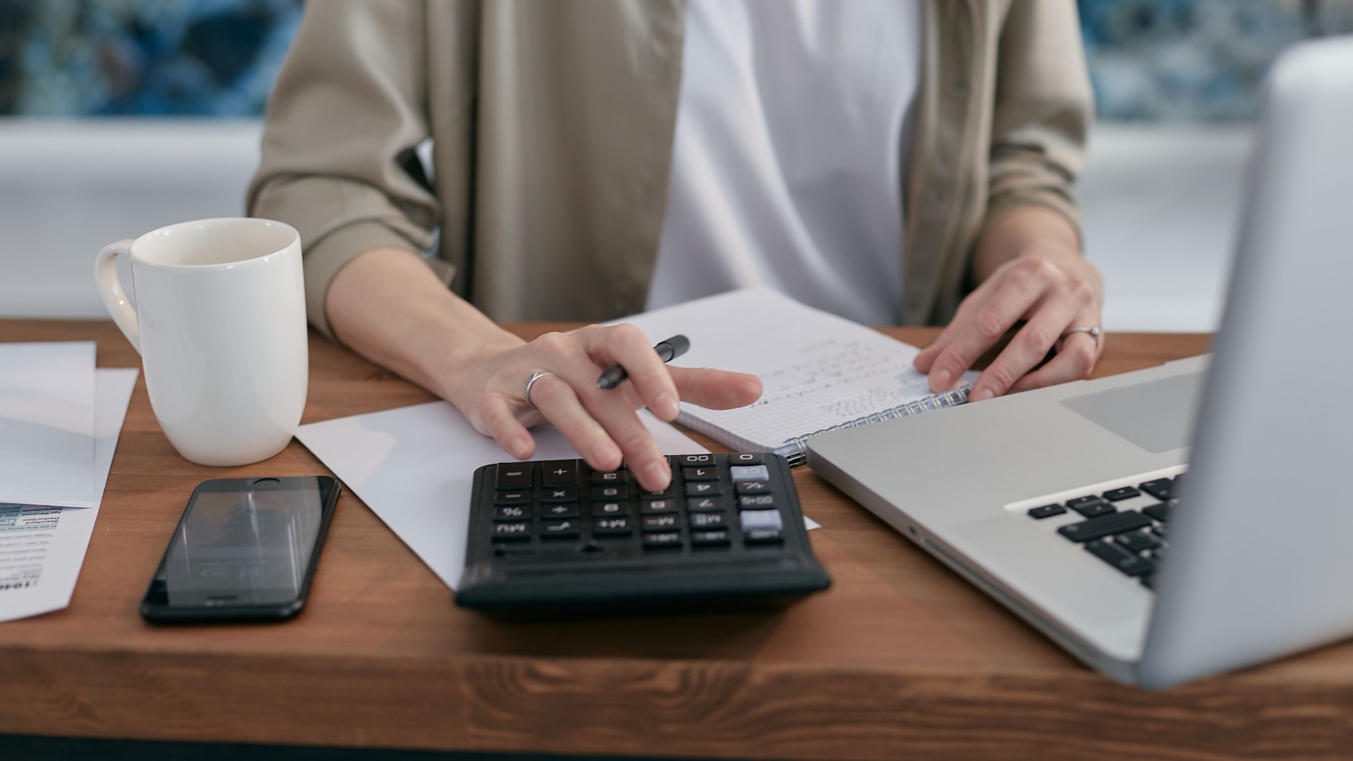 Two renters reviewing bills and calculating monthly housing expenses together.