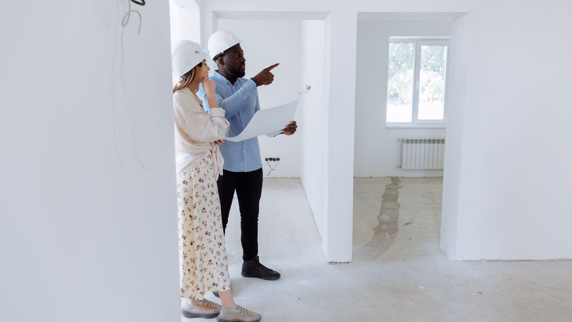 Image 1 alt text Property staff walking through a unit with a resident, pointing out details during a move-in inspection