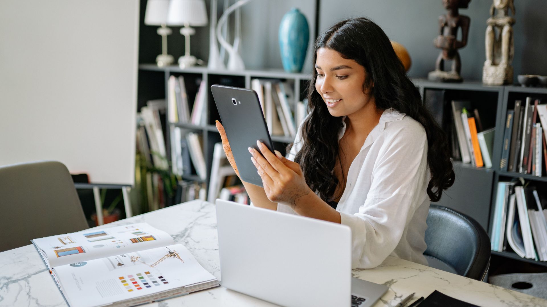 Property manager reviewing information on a tablet at her desk