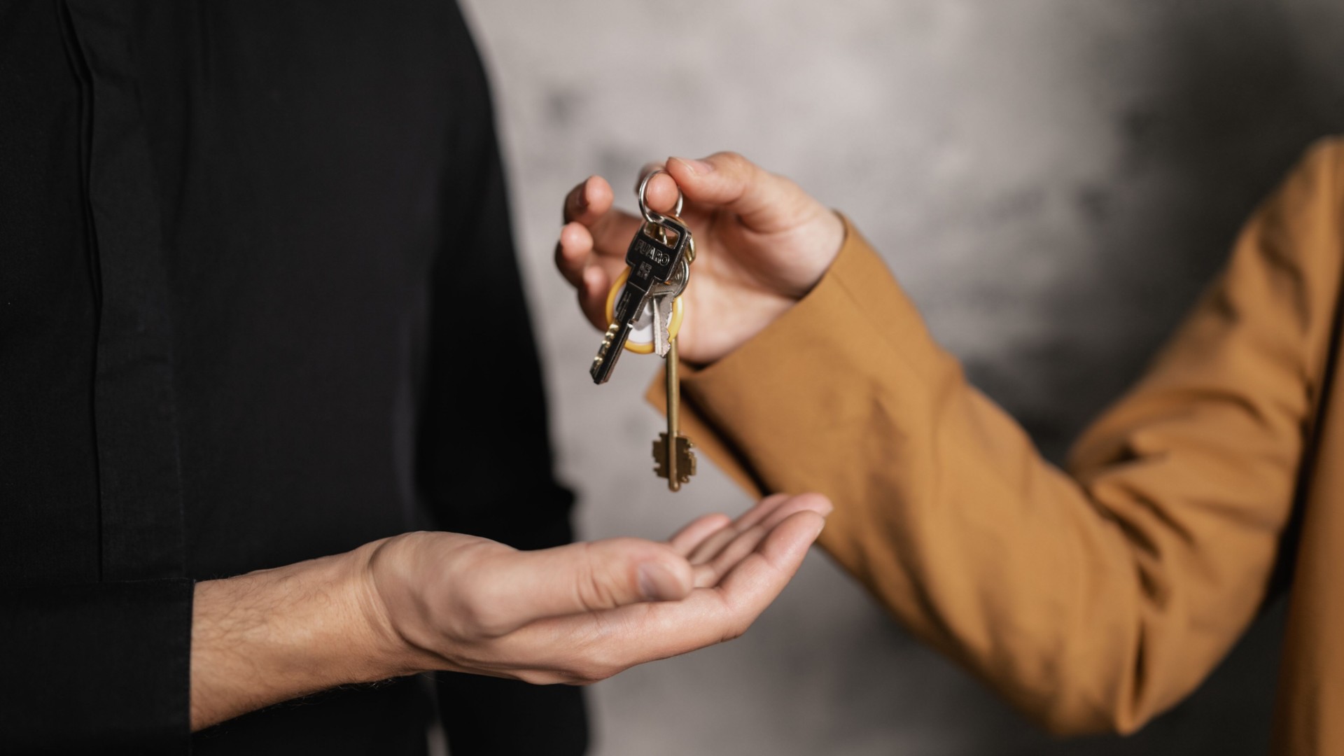 Leasing agent handing over keys to a new resident