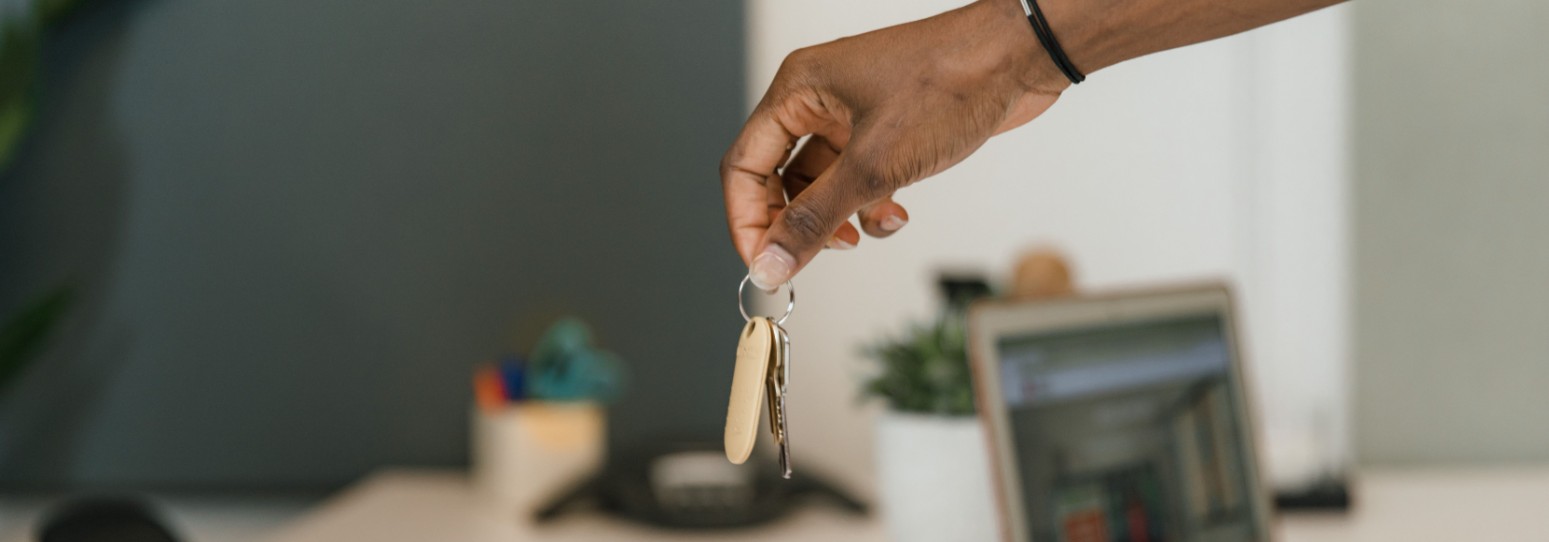 a person holding keys over a counter