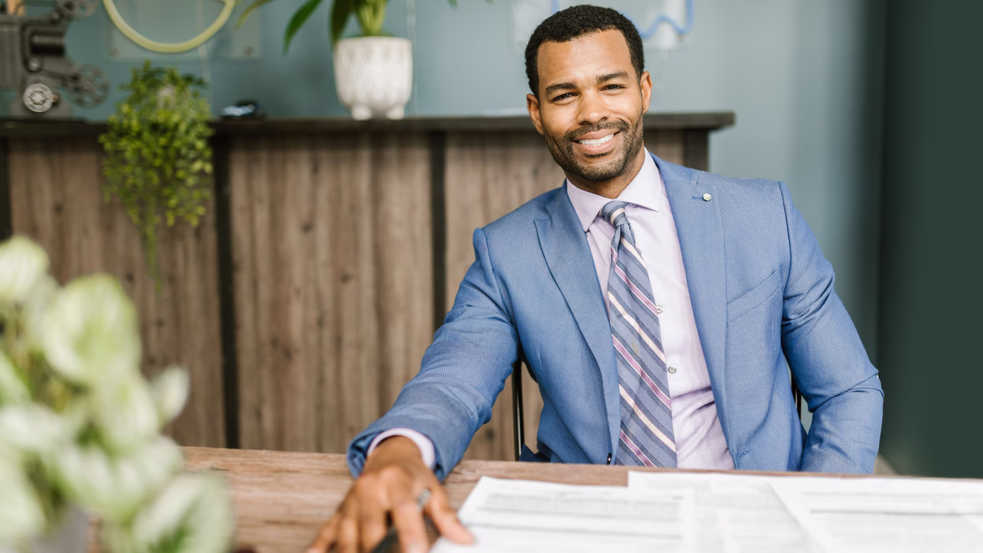 A leasing agent sitting at a desk smiling