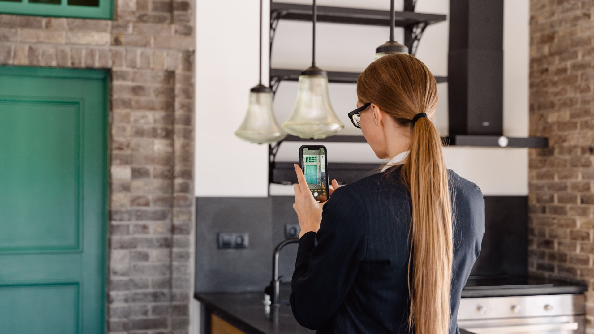 A person taking photos of an apartment with their smartphone 