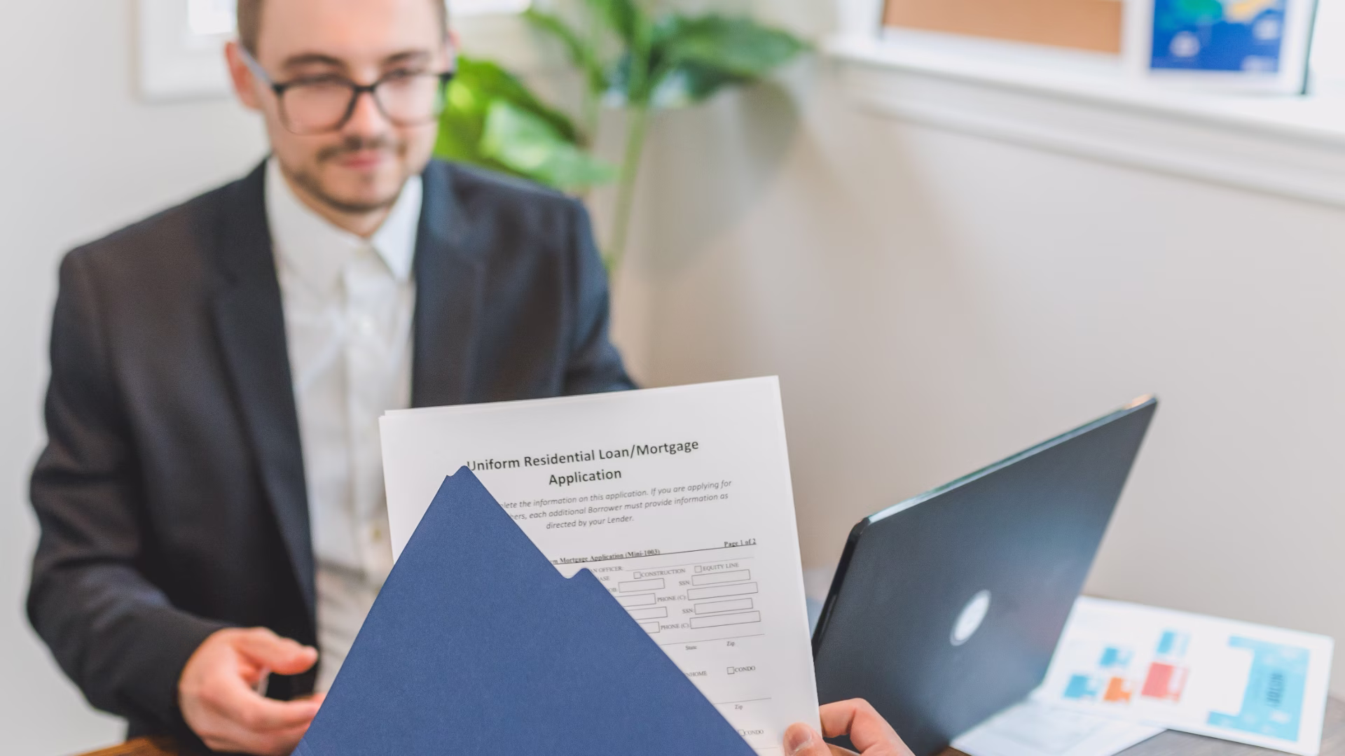leasing consultant reviewing application with prospective resident