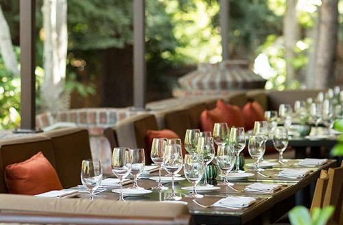 Harvest Table st helena dining room surrounded by gardens