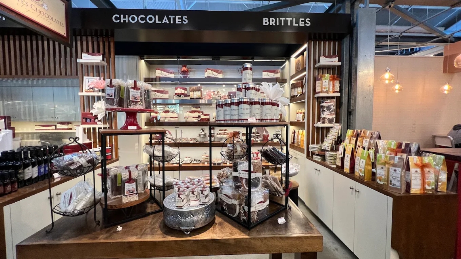 Annette's Chocolates storefront showcases an upscale chocolate and brittles shop with elegant display cases featuring artisan confections, decorative shelving, and premium product packaging.