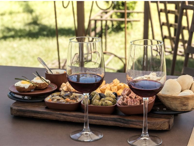 Napa Valley wine tasting with cheese and picnic spread outdoors