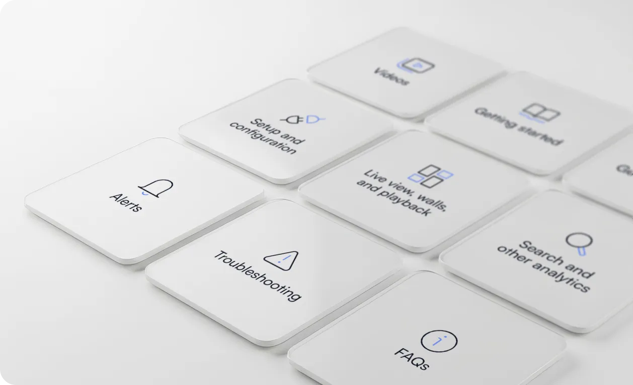 White square tiles with black and blue icons and text for support topics like Alerts, Setup and configuration, Live view, walls and playback, Troubleshooting, FAQs, Videos, Getting started, and Search and other analytics.