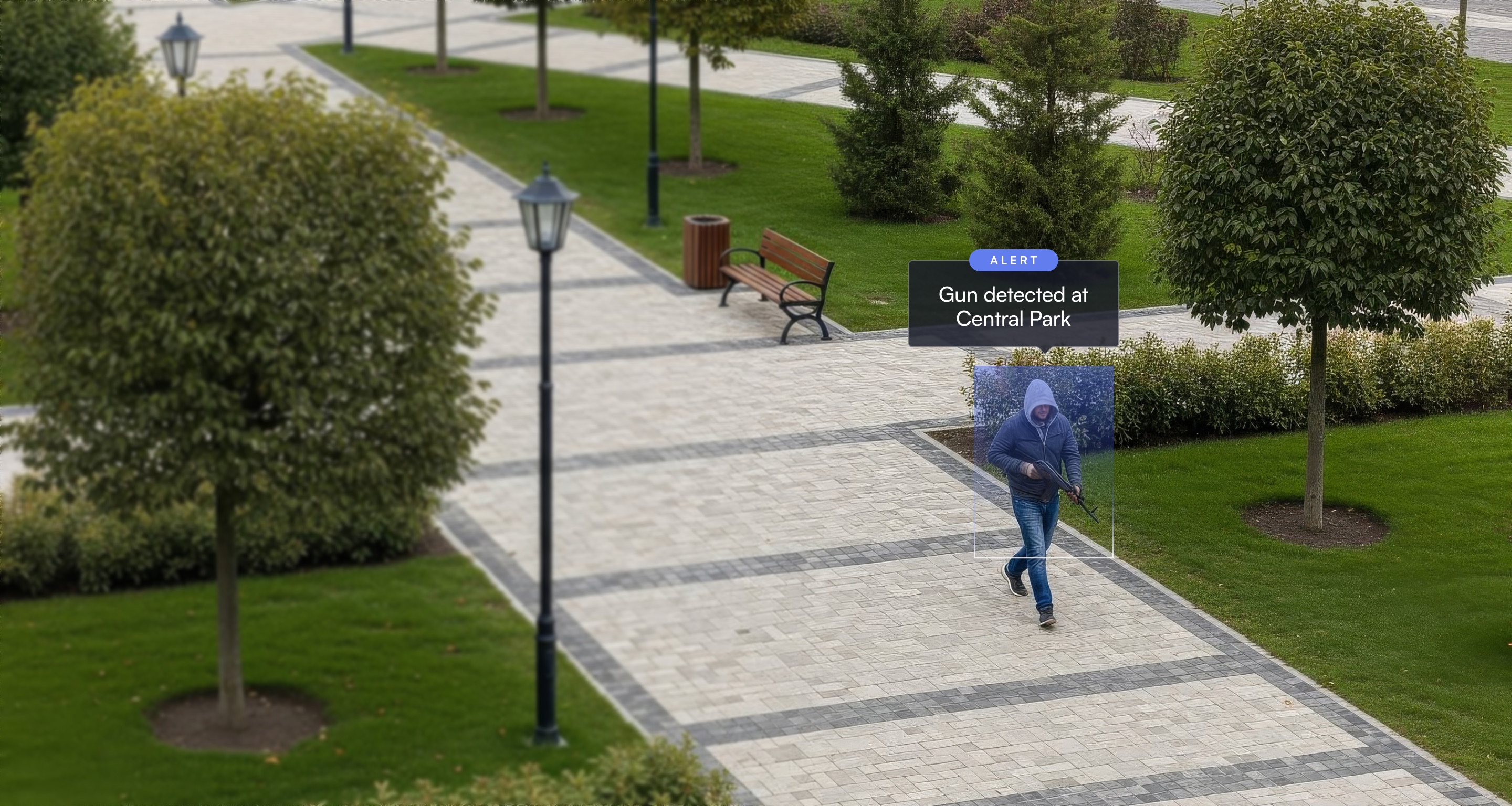 Man in hoodie walking in a park holding a long gun with an alert indicating 'Gun detected at Central Park.'