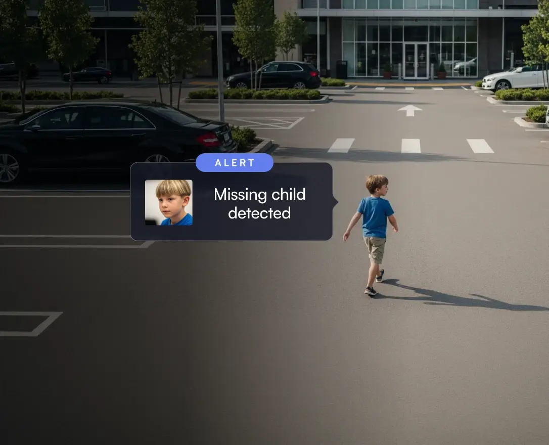 Young boy in blue shirt and khaki shorts walking alone in an empty parking lot with an alert notification identifying him as a missing child.