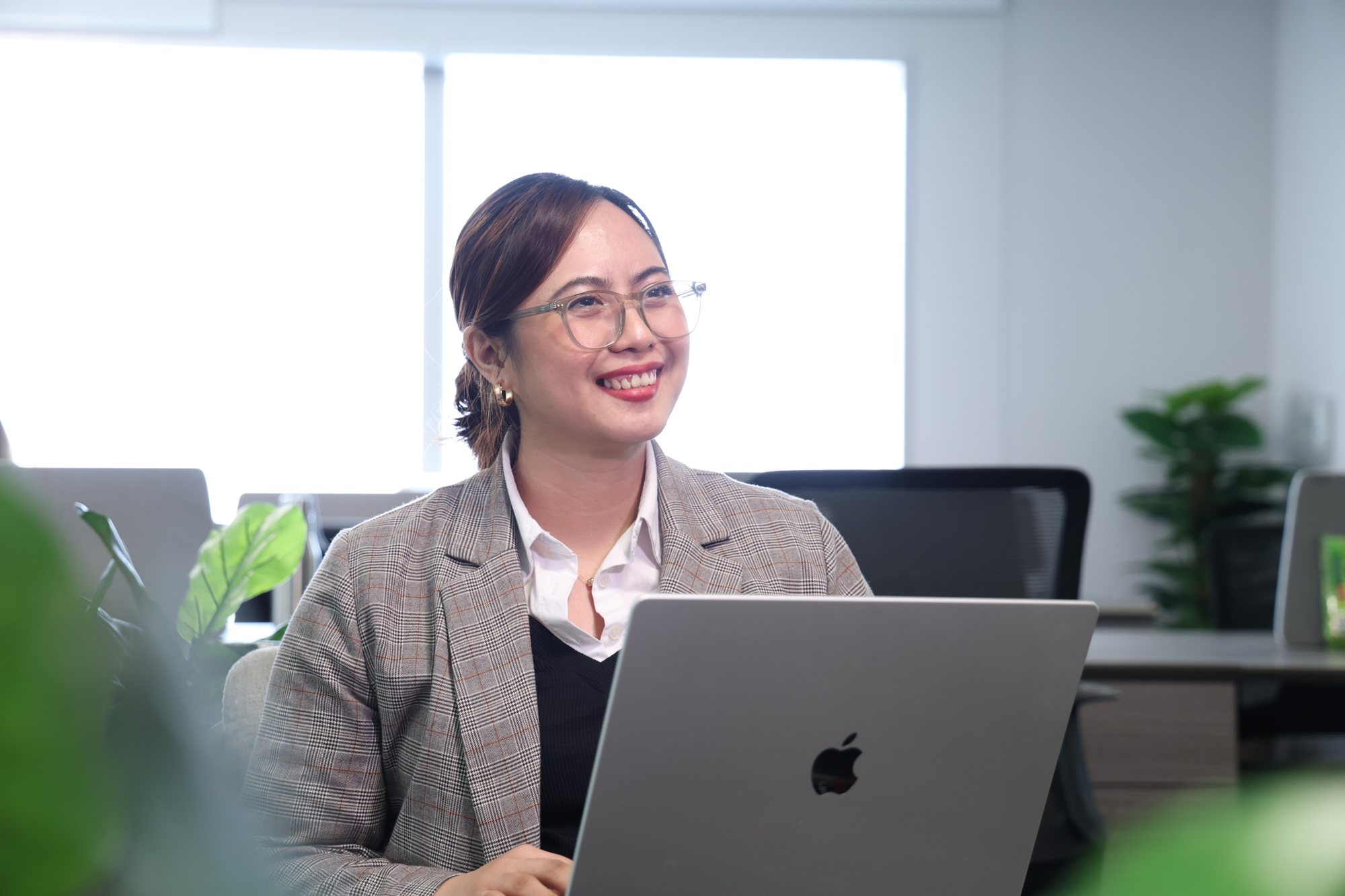 Smiling professional working on a laptop