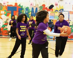 Group of students playing basketball during an after-school sports program