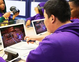 Students using tablets and stylus pens during an interactive digital technology lesson