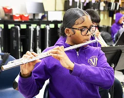Student playing the flute during school band practice