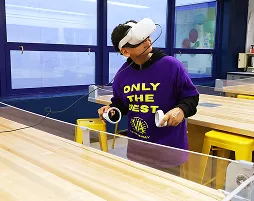Student wearing a VR headset while participating in an immersive technology lesson