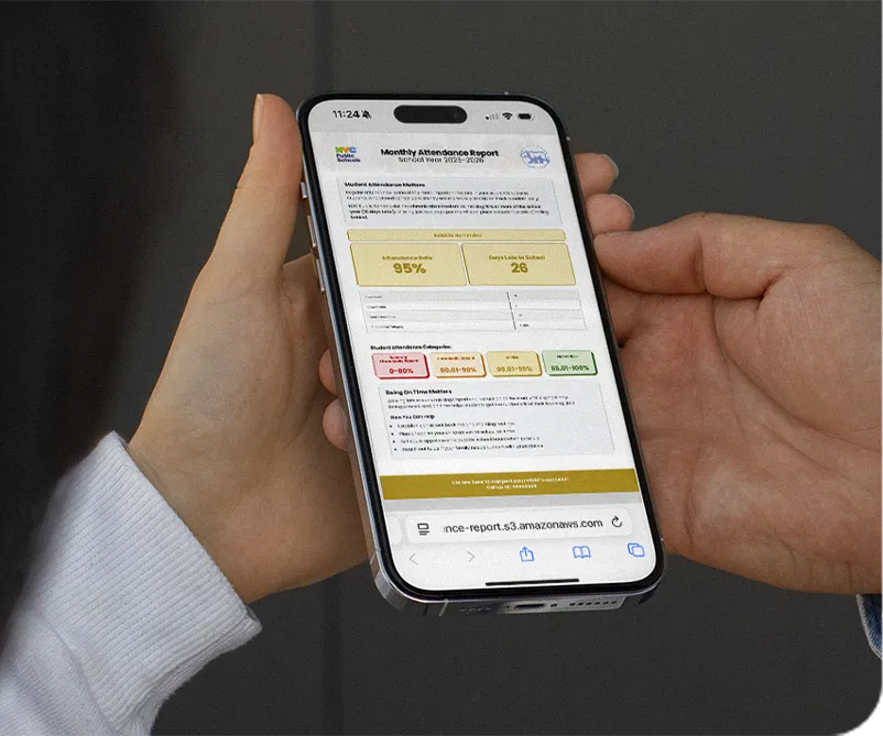 Close-up of hands holding a smartphone displaying a personalized attendance report SMS from a K-12 school