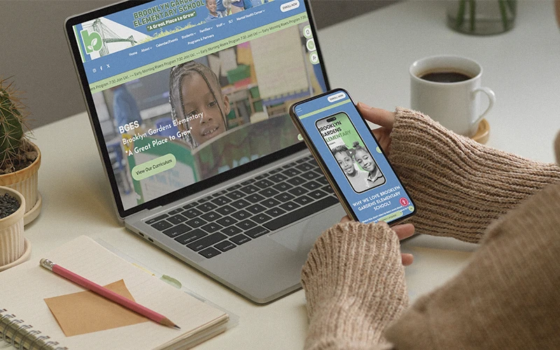 Parent viewing a school’s branded website on a laptop and mobile app, showing cohesive design across devices and platforms.