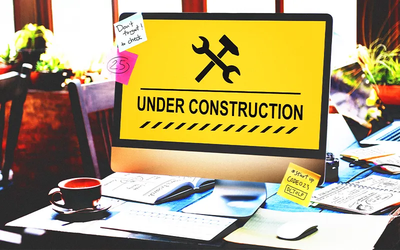 Illustration of a school website under construction representing ongoing updates and improvements