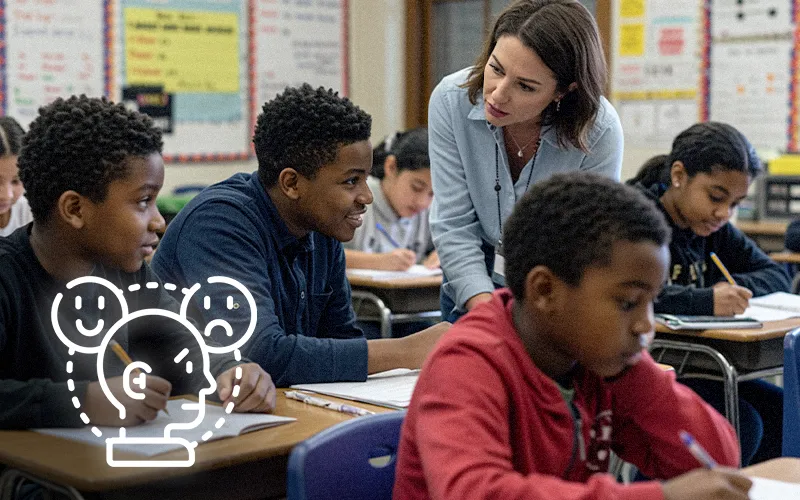 Teacher checks in calmly with a student while classmates work quietly during Tier-1 routines