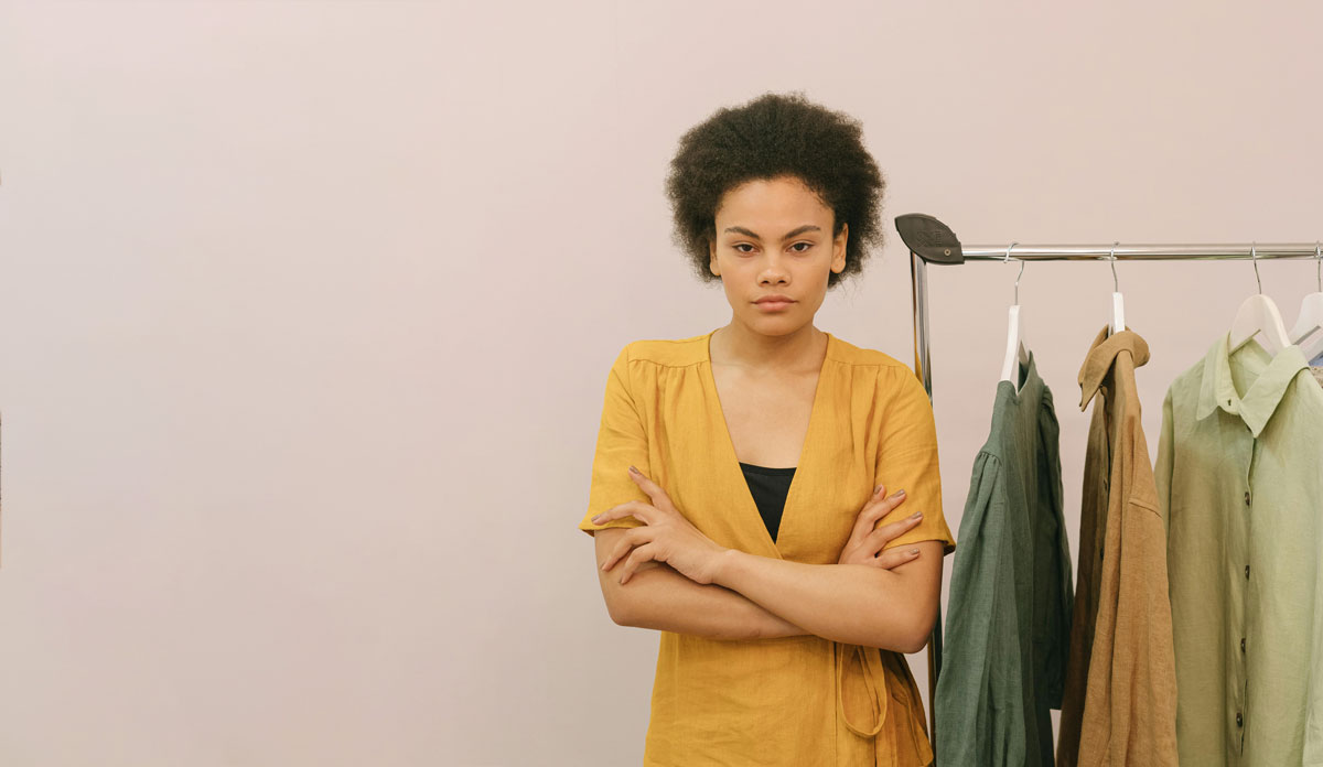 woman standing near the cloth rack