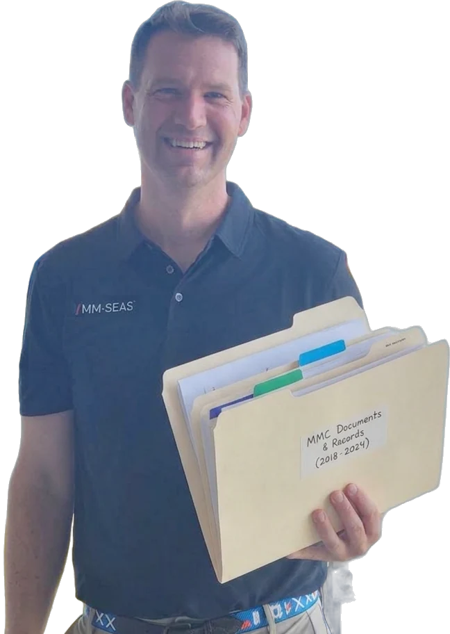 An MM-SEAS licensing expert holding a mariner's MMC documents